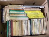 a lot of books in a box on the floor