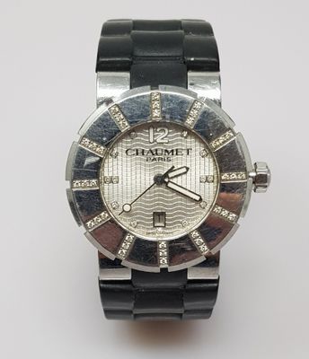 a close up of a watch on a white surface