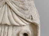 marble statue of a woman with a veil on her head and a bird on her shoulder