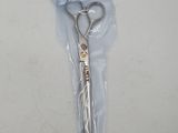 a pair of scissors in a plastic bag on a table