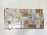 a metal box with many different colored tiles on it