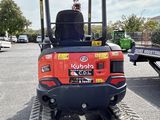 a small tractor that is parked in the parking lot
