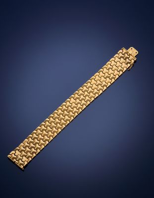 a gold bracelet on a blue background