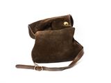 the small brown bag is sitting on a white surface
