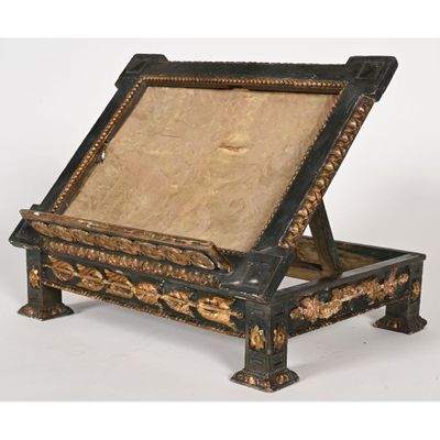 an image of a black and gold painted wooden desk with a beige cushion