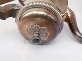 a silver coffee pot with a handle on a white table