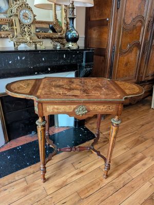 a wooden table with a marble top in a living room