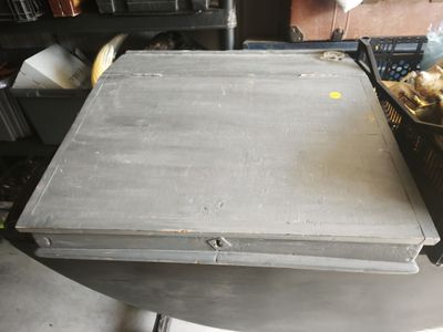 a metal box sitting on top of a table in a room