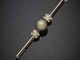 a black pearl and diamond bar broochle