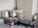 many pans and pans sitting on a table in a kitchen
