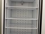 an empty refrigerator that is sitting in a room