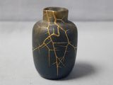 a small vase that has a cracky surface on it