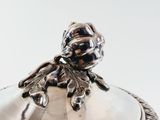 a silver plate with a bird on top of it
