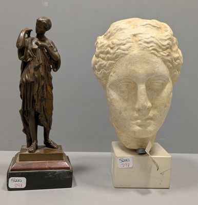 a statue of a woman standing next to a statue of a man