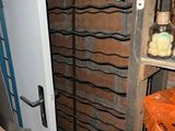 a closet with a shelf full of clothes and other items