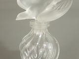 a glass vase with a flower inside of it