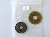 two chinese coins sitting on top of a plastic bag