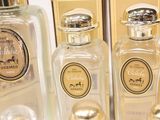 three bottles of perfume sitting next to each other on a table