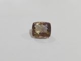 a cushion cut smokyite gemstone on a white surface