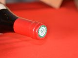 a bottle of wine on a table with a red table cloth