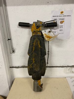 a metal fire hydrant that is sitting on a table