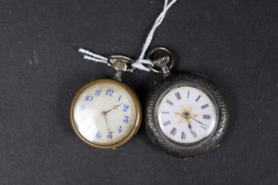 two pocket watches that are sitting on a black surface
