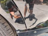 a reflection of a man in a mirror on the side of a car