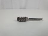 a close up of a small metal tool on a white surface
