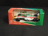 a toy car in a box on a black surface