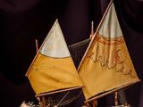 a small model of a sailboat on a wooden table