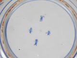 a blue and white plate with chinese writing on it