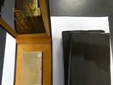 a box with a lighter and a wallet on a table