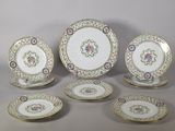 six pieces of porcelain dishes and plates with gold trim