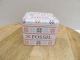 a small tin box with a cross stitch design on it