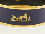 bracelet with a horse drawn carriage on it and a man on a cart