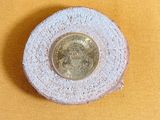 a small piece of bread with a coin on top of it