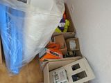 a pile of electronics on the floor next to a refrigerator