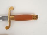 an image of a gold and red sword on a white surface