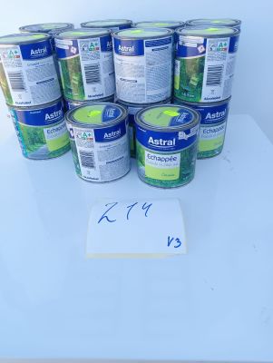several cans of astrall on a table with a price tag