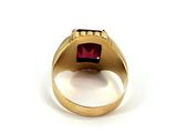 an image of a gold ring with a red stone in the center