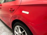 a red car with a sticker on the side of it