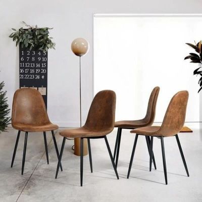 four chairs sitting in a room with a clock on the wall