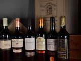 several bottles of wine are lined up on a table
