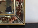 a mirror that is sitting on a table with a person taking a picture