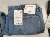 a pair of jeans and a pair of shoes next to each other