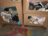 two cardboard boxes with clothes on them in a room