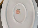a white plate with a gold rim sitting on a table