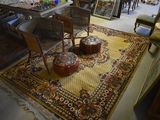 a rug on the floor in a room with a table and chairs