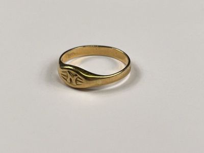 a close up of a gold ring on a white surface