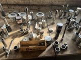 many different types of metal pipes and valves on a table